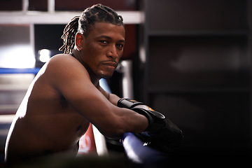 Image showing Portrait, fitness and black man boxer in ring at gym for combat sports training or competition. Exercise, boxing or fighting with shirtless young athlete on break from intense self defense workout