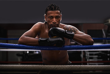 Image showing Portrait, exercise and black man boxer in ring at gym for combat sports training or competition. Fitness, boxing or fighting with shirtless young athlete on break from intense self defense workout