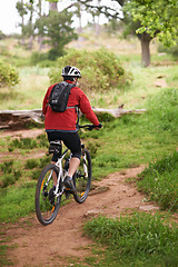 Image showing Fitness, bike and man cycling in nature for adventure, discovery or off road sport hobby. Exercise, health and wellness with athlete or cyclist on bicycle in countryside for cardio training from back
