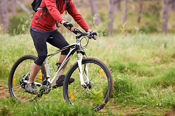 Image showing Bike, wheels and person cycling in countryside for fitness, health or off road trail hobby outdoor. Exercise, sports or training with athlete or cyclist on bicycle in nature for cardio workout