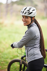 Image showing Nature, cycling and portrait of woman with bicycle for fitness in an outdoor park training for race or marathon. Sport, exercise and female cyclist walking with bike for workout in field or forest.