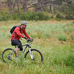 Image showing Fitness, bike and man cycling in countryside for adventure, discovery or off road sports hobby. Exercise, health and wellness with young cyclist on bicycle in nature for cardio training or workout