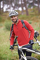 Image showing Portrait, bike and man cycling in nature for adventure, discovery or off road sports hobby. Exercise, fitness and wellness with young cyclist on bicycle in countryside for cardio training or health