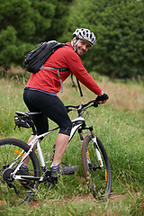 Image showing Portrait, bike and man cycling in countryside for adventure, discovery or off road sports hobby. Fitness, health and wellness with young cyclist on bicycle in nature for cardio training or exercise