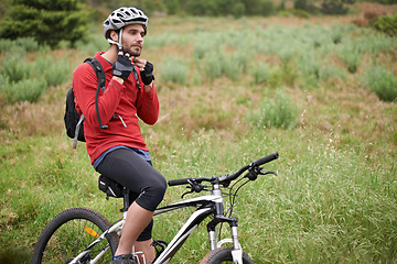 Image showing Fitness, bike and man cycling with helmet for adventure, discovery or off road sports hobby. Exercise, health and safety with young cyclist on bicycle in countryside for cardio training or workout