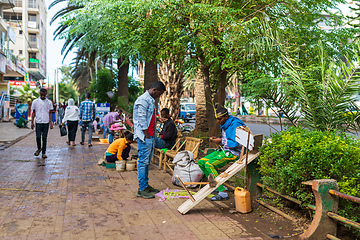 Image showing Shoe cleaner on the street during Easter holiday, Bahir Dar, Ethiopia