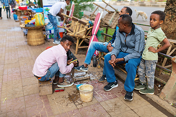 Image showing Shoe cleaner on the street during Easter holiday, Bahir Dar, Ethiopia