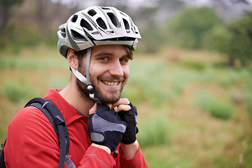 Image showing Cycling, happy man and portrait in helmet for safety, protection and gear to travel outdoor in Canada. Bicyclist, face and person with hat getting ready for training, sports and fitness in nature