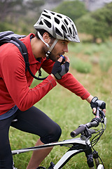 Image showing Fitness, cycling and drinking water with man in countryside for adventure, discovery or off road sports hobby. Exercise, health and hydration with young athlete on bike for cardio training or workout