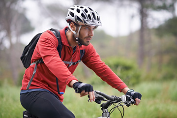 Image showing Health, bike and man cycling on forest field for adventure, discovery or off road sports hobby. Exercise, fitness and wellness with serious young cyclist in nature for cardio training or workout