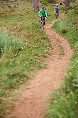 Image showing People, bike or cycling outdoor on trail for exercise, workout or adventure in forest with fitness. Friends, cyclists or bicycle with helmet in woods or off road for sport, hobby or travel in nature