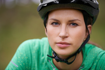 Image showing Portrait, cycling and helmet with woman closeup in nature for fitness, training or off road hobby. Face, exercise and health with confident young athlete or cyclist outdoor in countryside for cardio