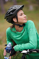 Image showing Thinking, bicycle and woman in nature to exercise with water bottle outdoor for hydration. Bicyclist, cycling and female person on bike to travel on journey, adventure or workout for sports in summer