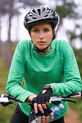 Image showing Nature, cardio and portrait of woman with bicycle for fitness in an outdoor park training for race or marathon. Sport, exercise and female athlete cyclist riding bike for workout in field or forest.