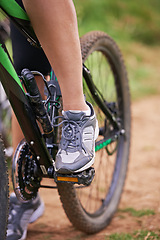 Image showing Cycling, legs and person on bicycle outdoor for exercise, workout or fitness for sports. Mountain bIke, rider and shoes of bicyclist in nature to travel on transport, journey or closeup of adventure