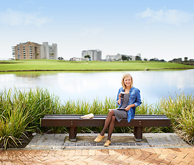 Image showing Woman, relax and portrait in park with coffee, book and happy with lunch on bench outdoor in Russia. Girl, smile and sitting at lake with espresso, latte and enjoy break from studying at college