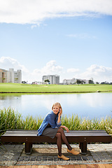 Image showing Lake, park and woman on bench on a phone call for communication, social networking and chat. Relax, city and happy person with smartphone for talking, conversation and speaking outdoors on weekend