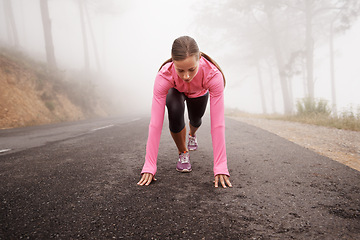 Image showing Runner, start and woman on path outdoor in forest, park or woods for exercise in winter. Morning, fog and person with fitness challenge or prepare for workout on road in countryside with nature