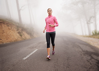 Image showing Nature, sports and woman running in fog on mountain road for race, marathon or competition training. Fitness, exercise and female athlete with cardio workout in misty outdoor woods or forest.