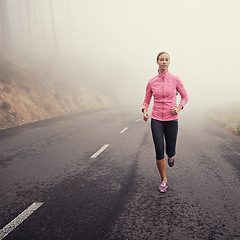 Image showing Nature, fitness and woman athlete running on mountain road for race, marathon or competition training. Sports, exercise and female person with cardio workout in misty outdoor woods or forest.