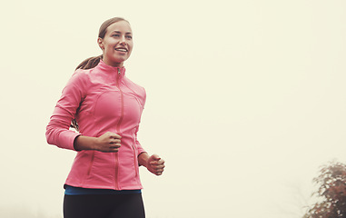 Image showing Nature, energy and woman athlete running on mountain road for race, marathon or competition training. Sports, exercise and female with cardio workout for fitness in misty outdoor woods or forest.