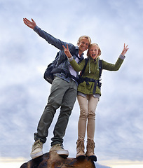 Image showing Couple, hiking and excited on mountain top for travel, success and achievement with peace sign on cloudy sky. Portrait of happy people in backpack for trekking, journey or adventure with a low angle