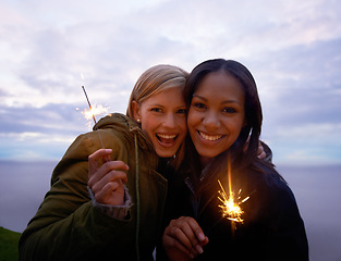 Image showing Women, friends and portrait with sparklers in nature celebration and fun with smile or travel outdoor. Friendship, bonding and sparks with horizon, happy for adventure together and evening sky