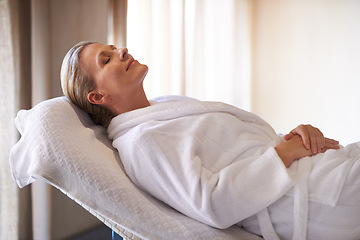 Image showing Woman, calm and smile for wellness, spa and healthy weekend getaway at luxury retreat in Amsterdam. Peaceful, holistic and female person for rest on table with robe, eyes closed and happiness