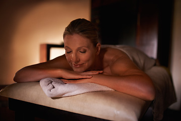 Image showing Woman, smile and relax for wellness, spa and healthy weekend getaway at luxury retreat in Amsterdam. Female person, rest and eyes closed with lying, massage table and peace for holistic self care