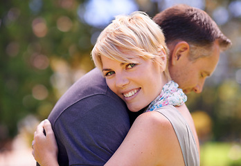 Image showing Hug, love and couple in nature with support, commitment and trust, care and solidarity while bonding in a park. Safety, security and people embrace in a garden with peace, calm or soulmate connection