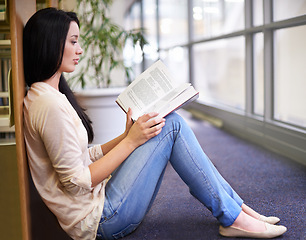 Image showing Student, reading and knowledge from education in library, calm and research for assignment or homework. Girl, learning and study with book in school, information and proud for literature in college