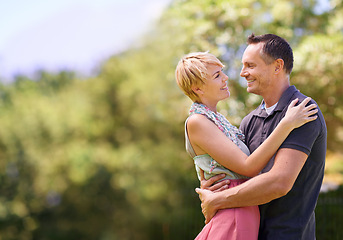 Image showing Love, smile and happy couple hug in park with trust, support or solidarity, security or bonding in nature. Commitment, eye contact or people embrace in forest for spring romance, fun or outdoor date