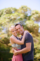 Image showing Portrait, love, and happy couple hug in a park with trust, support or solidarity, security or bonding in nature. Commitment, face or people embrace in a garden for spring romance, fun or outdoor date