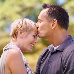 Image showing Couple, love and kiss on forehead with happiness in outdoor, affection and romance with date. Closeup, relationship and together with smile for bonding, care and trust with commitment for support