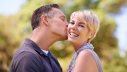 Image showing Portrait, couple and love with kiss in happiness on outdoor, affection and romance with date. Park, relationship and together with smile for bonding, care and trust with commitment for support