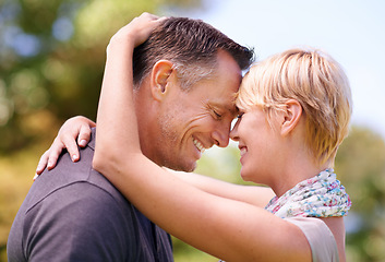 Image showing Love, hug and couple in nature with romance, support and trust, bonding and sharing sweet moment outdoor together. Safety, smile or happy people embrace in a forest for summer date, solidarity or fun