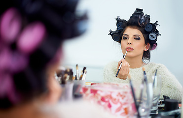 Image showing Woman, face and hair curlers or lipstick for beauty in mirror and haircare, self care or cosmetology. Model, person or hairstyle for morning routine, curling or getting ready for wellness or grooming