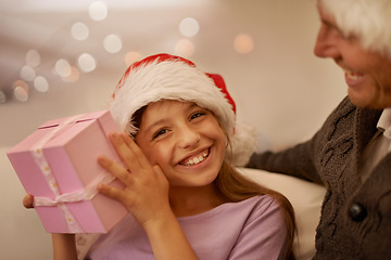 Image showing Christmas, sofa and portrait of child with gift box, dad and celebration together with happy surprise. Holiday, father and daughter smile on couch for present giving, festive xmas and love in home.