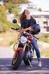 Image showing Woman, motorcycle and relax with helmet in city for ride, road trip or outdoor sightseeing in nature. Extreme female person, biker or rider chilling on motorbike or vehicle for transport or journey