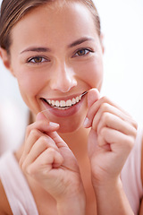 Image showing Woman, teeth and floss in portrait for dentistry with closeup, morning and cleaning mouth for dental hygiene. Female person, tooth care and daily routine for healthy, white and fresh smile for beauty