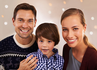 Image showing Christmas, family and happy kid with parents in home for love, connection and bonding at festive celebration with bokeh. Xmas, face and child with mother, father and together at party on holiday