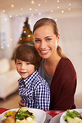 Image showing Mother, kid and portrait with Christmas dinner for celebration, smile and bonding over festive season. Parent, child and together for meal with xmas decoration and holiday with food for family