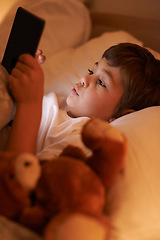 Image showing Boy, tablet and bedroom with night, connection and technology for social media or learning. Child, bed and connectivity for knowledge, elearning and internet surfing at home or house with touchscreen