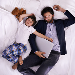 Image showing Tired, businessman and sleep with son, laptop for rest with technology and suit. Father, child and bedroom with fatigue, love and above with freelance peace or remote work for stress management