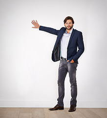 Image showing Portrait, man and showing for presentation with smile, confidence and business attire in studio. Businessman, professional designer and advice for client, meeting and consultation on white background