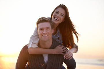 Image showing Portrait, piggy back and couple on beach at sunset for tropical holiday adventure, relax and bonding together. Love, happy man and woman on romantic date with ocean, evening sky and vacation