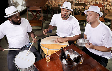 Image showing Musician, band and friends with beer, men and happy for drums, performance and party with alcohol. Group, artist and singing with bottle, drink and relax in pub for social event in Rio de Janeiro