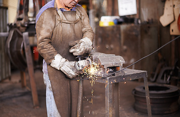 Image showing Blacksmith, person and grinder for metal with sparks, design or industry for metallurgy in factory. Man, worker or small business owner with power tools, steel or iron with manufacturing in warehouse