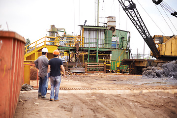 Image showing Crane, machine and engineer men in scrapyard to recycle metal for sustainability, manufacturing or pollution. Vehicle, people and outdoor in junkyard for ecology with back, industry and environment