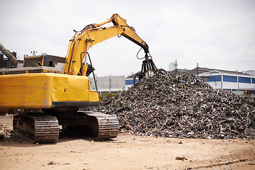 Image showing Crane, machine and scrapyard to recycle metal for sustainability, manufacturing or stop pollution. Vehicle, tractor and outdoor in junkyard, plant or ecology for iron, steel industry and environment